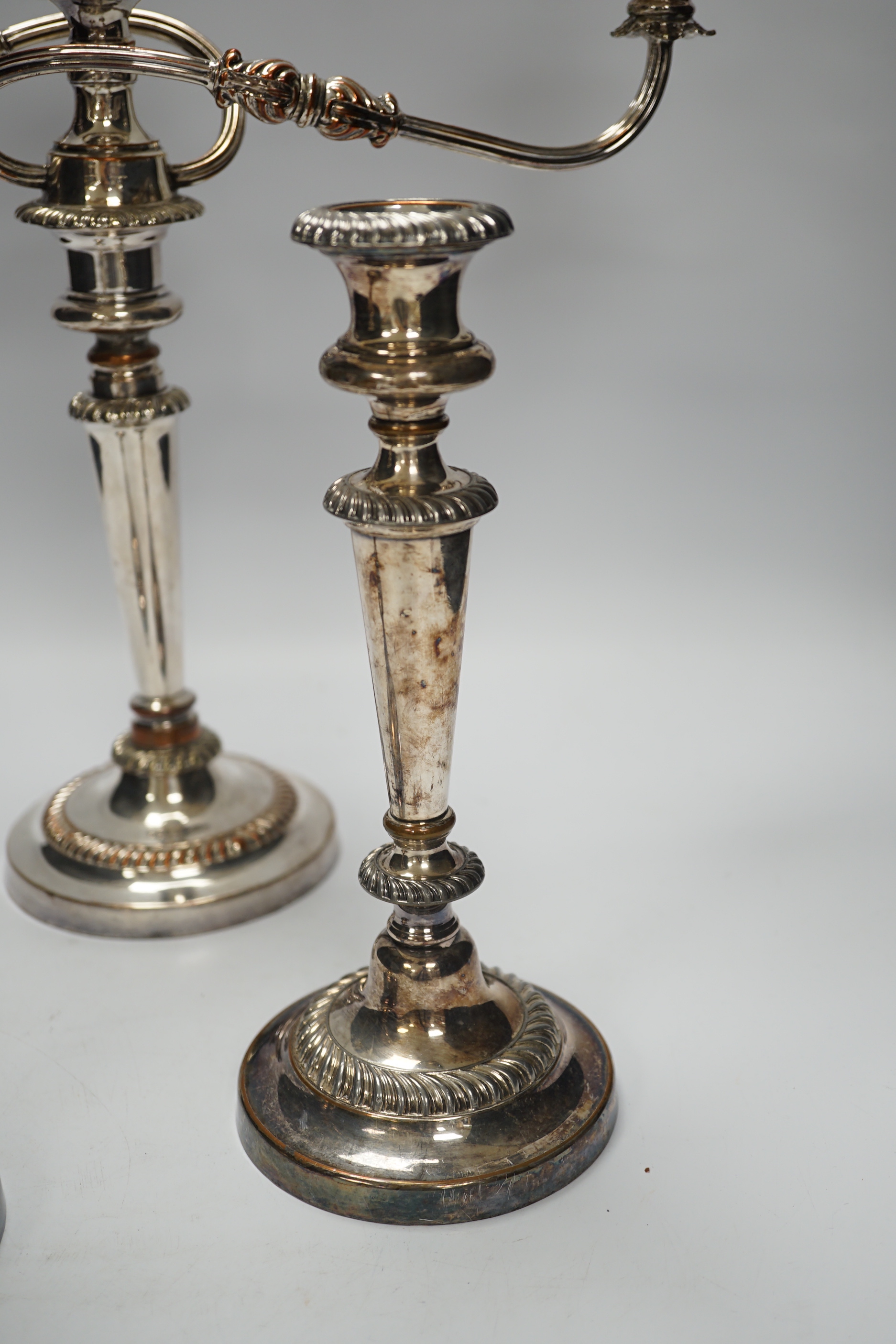 A Sheffield plate two branch, three light candelabra and a pair of candlesticks, candelabra 36cm high